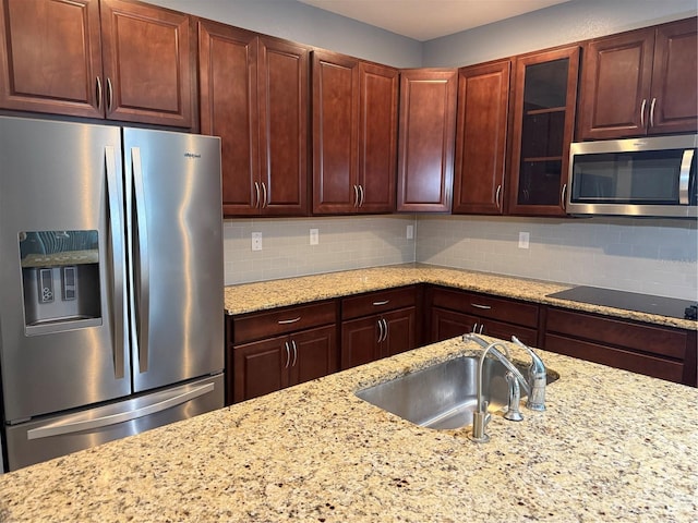 16856 Meadows St, Clermont, FL 34714 - kitchen with stainless steel appliances, glass insert cabinets, tasteful backsplash, and light stone counters