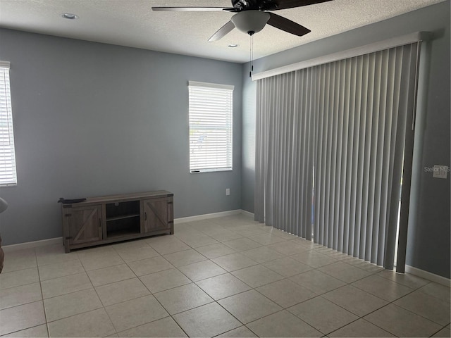 16856 Meadows St, Clermont, FL 34714 - empty room with ceiling fan, a textured ceiling, and light tile patterned floors