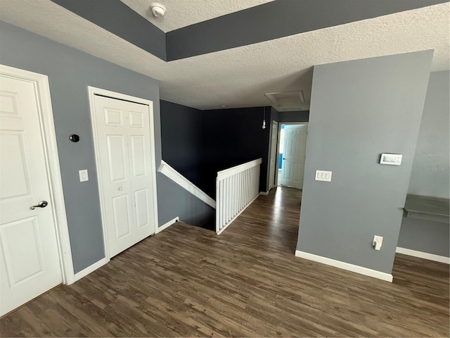 16856 Meadows St, Clermont, FL 34714 - unfurnished room featuring a textured ceiling, a smoke detector, wood finished floors, and attic access