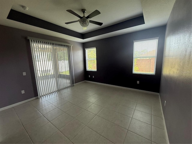 16856 Meadows St, Clermont, FL 34714 - tiled spare room with a raised ceiling, a ceiling fan, plenty of natural light, and a smoke detector
