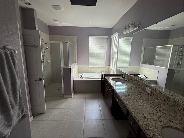 16856 Meadows St, Clermont, FL 34714 - bathroom featuring vanity, a shower stall, a bath, and tile patterned floors