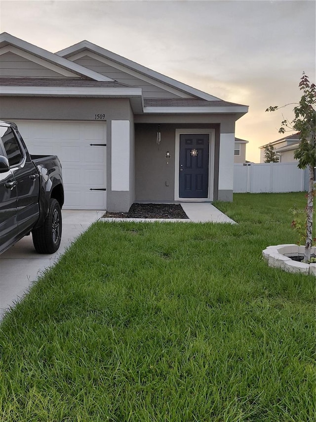 1509 Majestic, Winter Haven, FL 33880 - view of exterior entry featuring an attached garage, driveway, and stucco siding