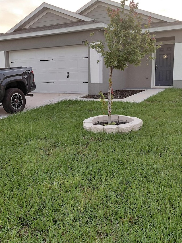 1509 Majestic, Winter Haven, FL 33880 - view of front of property with an attached garage, a front lawn, driveway, and stucco siding