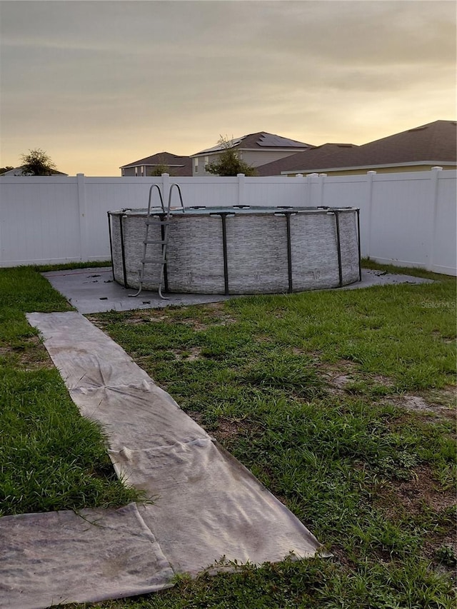 1509 Majestic, Winter Haven, FL 33880 - yard at dusk featuring a fenced backyard