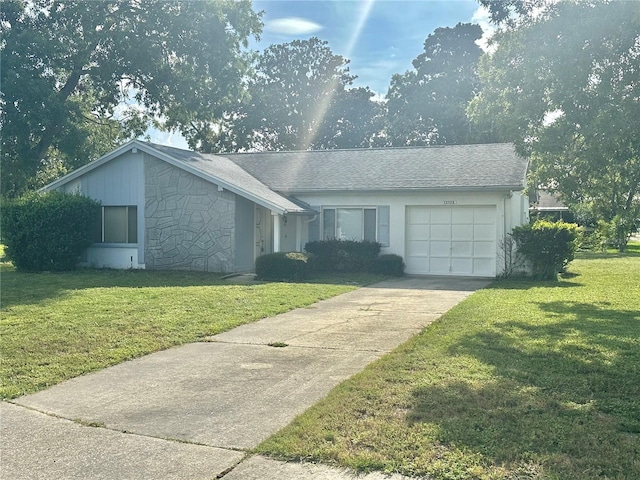 13102 Pembrook Ct, Hudson, FL 34667 - single story home featuring a garage, concrete driveway, a front yard, and stone siding