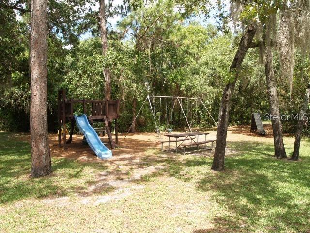 13102 Pembrook Ct, Hudson, FL 34667 - view of jungle gym with a lawn