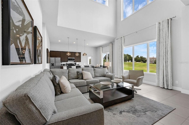 7740 Sandy Ridge Dr Unit 235, Reunion, FL 34747 - living room with a towering ceiling and light tile patterned floors
