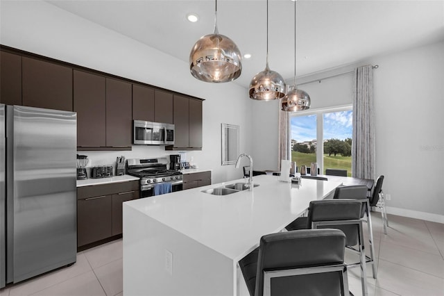 7740 Sandy Ridge Dr Unit 235, Reunion, FL 34747 - kitchen with stainless steel appliances, a breakfast bar, light tile patterned flooring, an island with sink, and recessed lighting