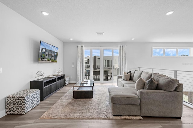 7740 Sandy Ridge Dr Unit 235, Reunion, FL 34747 - living area with recessed lighting, light wood finished floors, and a textured ceiling