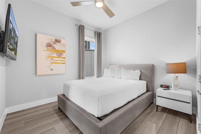 7740 Sandy Ridge Dr Unit 235, Reunion, FL 34747 - bedroom with light wood finished floors and ceiling fan