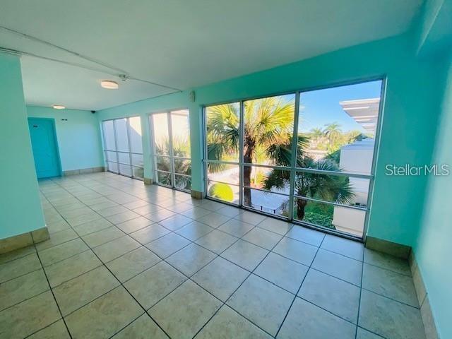221 Columbia Dr Unit 342, Cape Canaveral, FL 32920 - tiled empty room with healthy amount of natural light