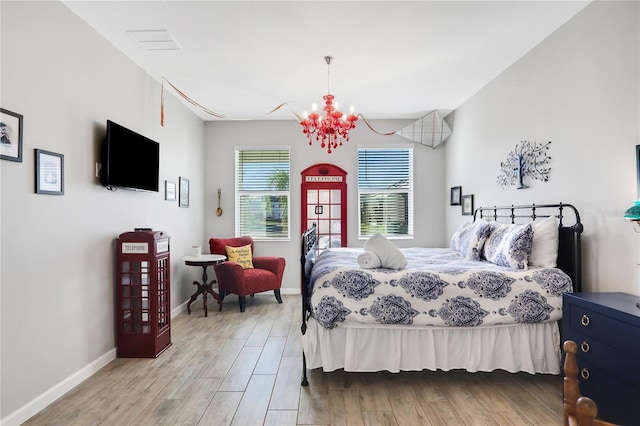 2541 Shanti Dr, Kissimmee, FL 34746 - bedroom with a chandelier and light wood-style flooring