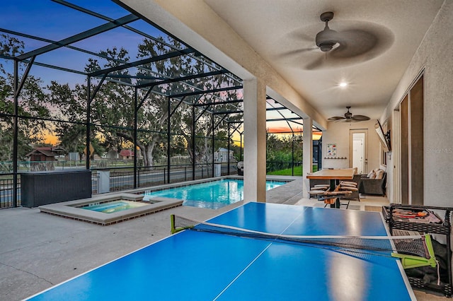 2541 Shanti Dr, Kissimmee, FL 34746 - pool at dusk featuring a ceiling fan, a patio, and a pool with connected hot tub