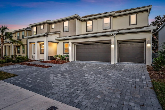 2541 Shanti Dr, Kissimmee, FL 34746 - prairie-style house with decorative driveway, stucco siding, and a garage