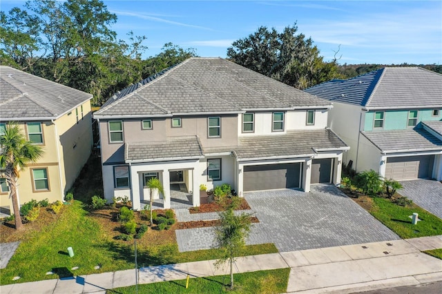 2541 Shanti Dr, Kissimmee, FL 34746 - traditional-style house with stucco siding, a garage, and decorative driveway