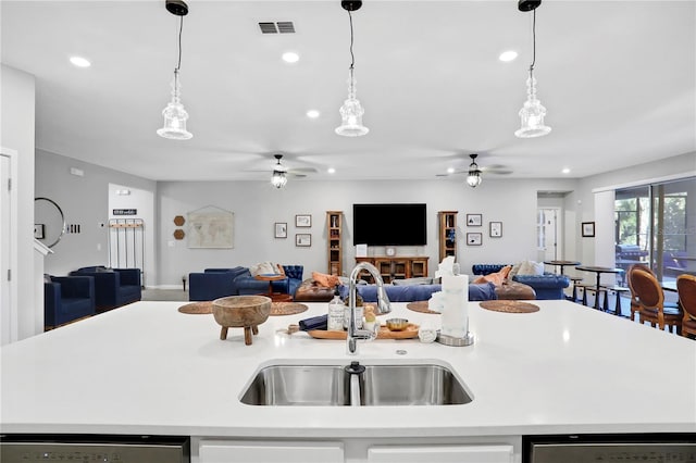 2541 Shanti Dr, Kissimmee, FL 34746 - kitchen featuring ceiling fan, open floor plan, light countertops, hanging light fixtures, and recessed lighting