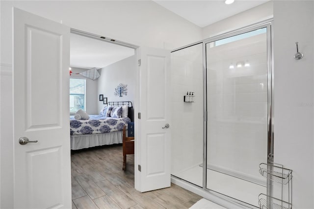 2541 Shanti Dr, Kissimmee, FL 34746 - full bath featuring connected bathroom, a shower stall, and wood finished floors