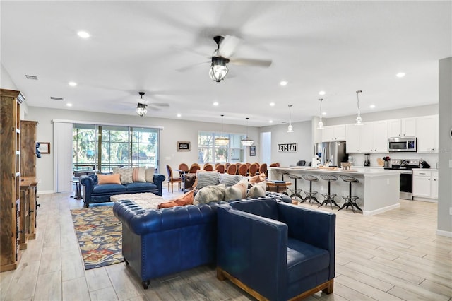 2541 Shanti Dr, Kissimmee, FL 34746 - living room with ceiling fan, recessed lighting, and light wood-type flooring