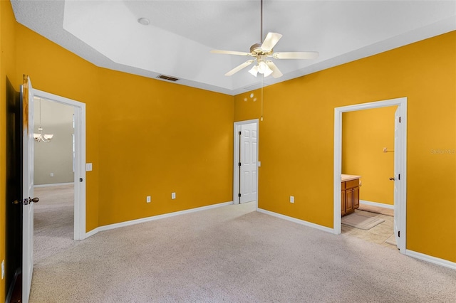 123 Preston Ave, Davenport, FL 33837 - unfurnished bedroom with light colored carpet, ensuite bathroom, and a ceiling fan