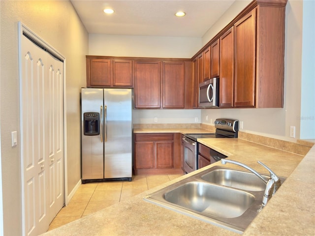 10238 Cala Lily Trl Unit S, Orlando, FL 32832 - kitchen with stainless steel appliances, light tile patterned flooring, recessed lighting, light countertops, and brown cabinets