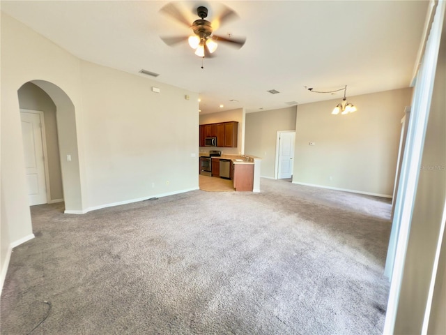 10238 Cala Lily Trl Unit S, Orlando, FL 32832 - unfurnished living room featuring arched walkways, ceiling fan, light carpet, and a chandelier