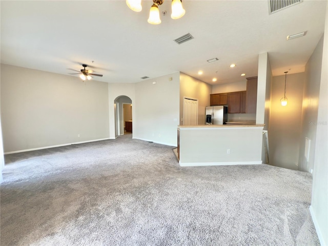 10238 Cala Lily Trl Unit S, Orlando, FL 32832 - unfurnished living room with arched walkways, carpet, ceiling fan, and recessed lighting