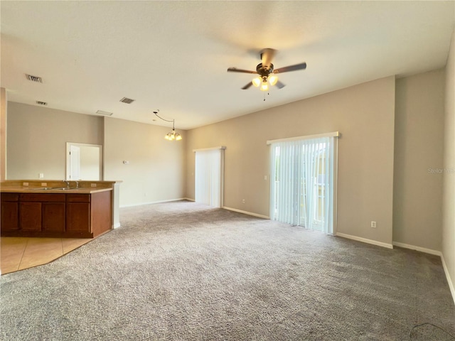 10238 Cala Lily Trl Unit S, Orlando, FL 32832 - unfurnished living room with light carpet, a ceiling fan, and a chandelier