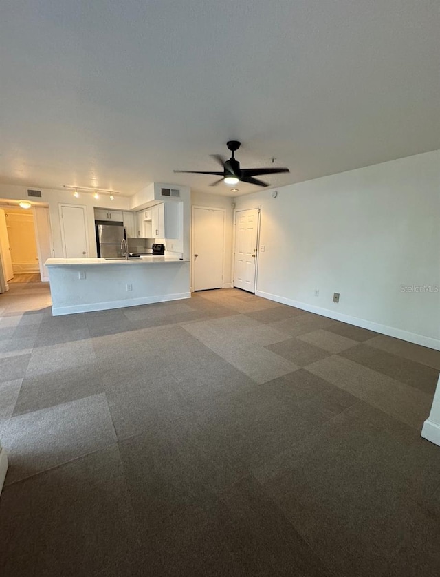 7280 Westpointe Blvd Unit 823, Orlando, FL 32835 - unfurnished living room with ceiling fan, carpet floors, and track lighting