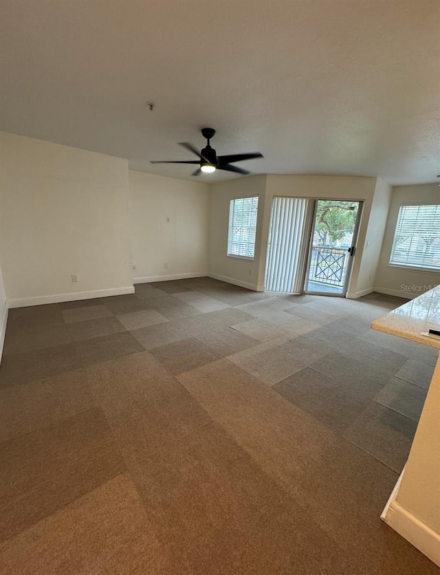 7280 Westpointe Blvd Unit 823, Orlando, FL 32835 - carpeted spare room with baseboards and a ceiling fan