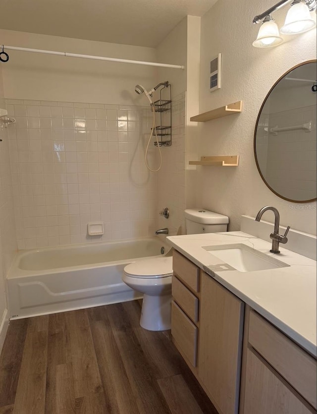 7280 Westpointe Blvd Unit 823, Orlando, FL 32835 - bathroom featuring vanity,  shower combination, wood finished floors, and a textured wall