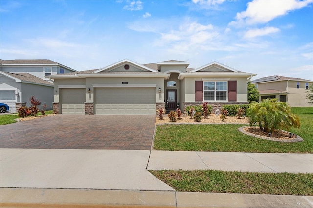 2215 Camden Park Ave, Davenport, FL 33837 - view of front facade featuring stone siding, a garage, decorative driveway, and stucco siding