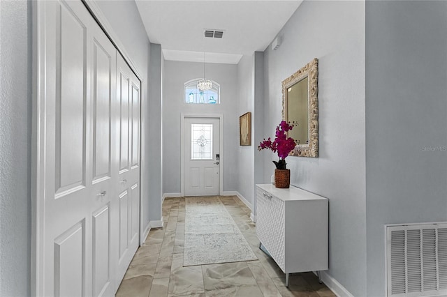 2215 Camden Park Ave, Davenport, FL 33837 - foyer entrance with light marble finish flooring and a chandelier