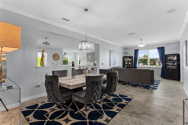 2215 Camden Park Ave, Davenport, FL 33837 - dining area with ornamental molding, light marble finish flooring, and a chandelier