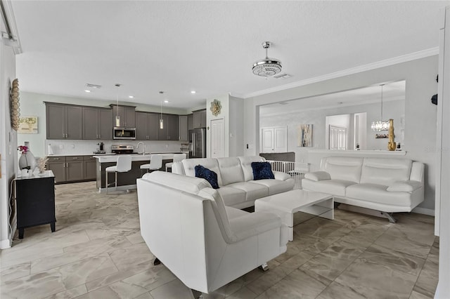 2215 Camden Park Ave, Davenport, FL 33837 - living room featuring light marble finish floors, crown molding, recessed lighting, and a chandelier