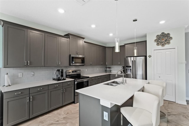 2215 Camden Park Ave, Davenport, FL 33837 - kitchen featuring light marble finish flooring, appliances with stainless steel finishes, a kitchen breakfast bar, backsplash, and pendant lighting