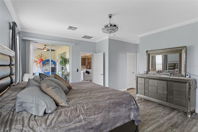 2215 Camden Park Ave, Davenport, FL 33837 - bedroom with wood finished floors, ornamental molding, a textured ceiling, and access to exterior
