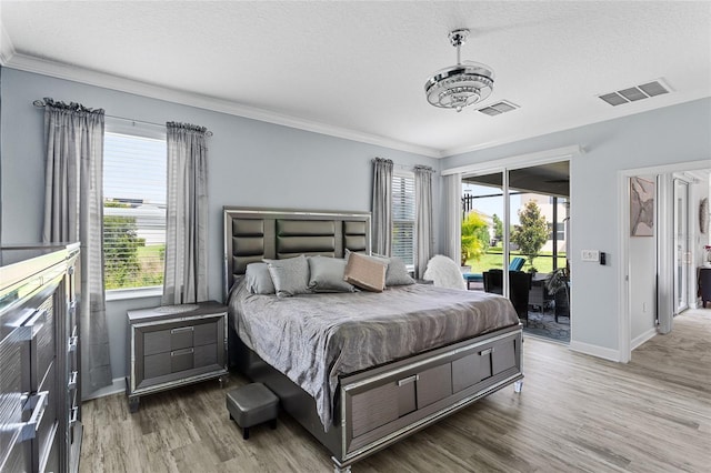 2215 Camden Park Ave, Davenport, FL 33837 - bedroom with access to exterior, wood finished floors, a textured ceiling, and ornamental molding