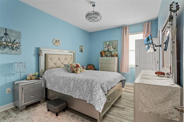 2215 Camden Park Ave, Davenport, FL 33837 - bedroom with light wood finished floors and baseboards