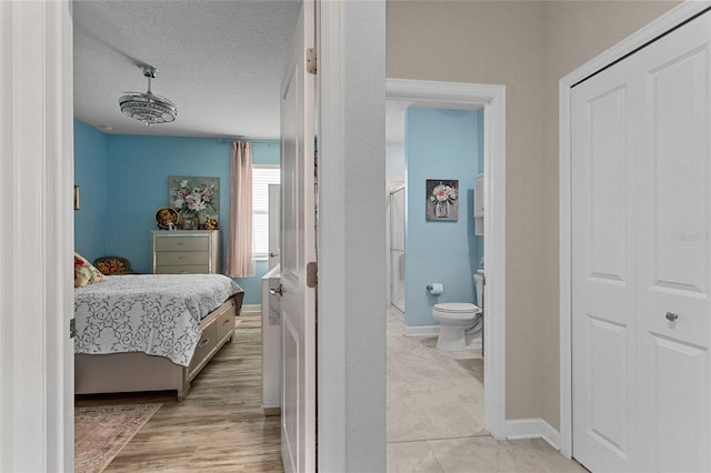 2215 Camden Park Ave, Davenport, FL 33837 - bedroom featuring a textured ceiling and ensuite bathroom