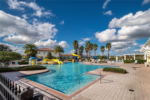 2215 Camden Park Ave, Davenport, FL 33837 - community pool featuring a water slide, a water play area, a patio, and a pergola