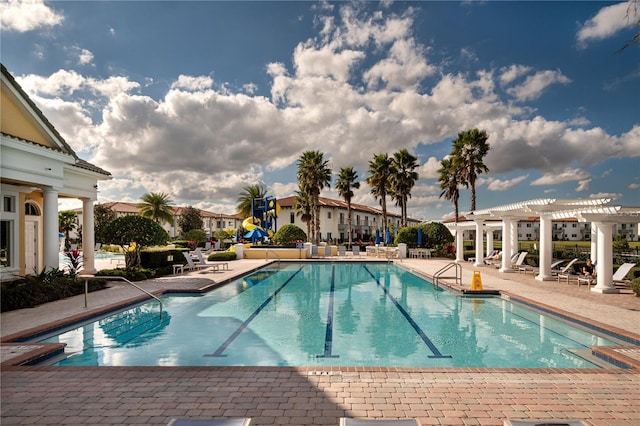 2215 Camden Park Ave, Davenport, FL 33837 - community pool featuring a pergola, a patio area, and a residential view
