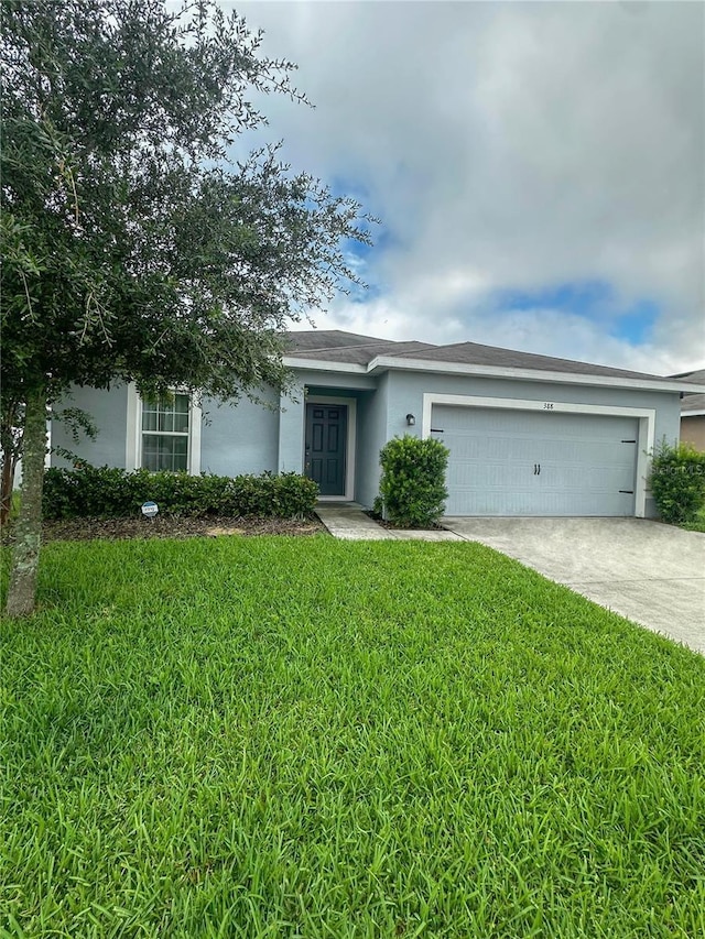 388 Rooks Loop, Haines City, FL 33844 - single story home featuring a garage, stucco siding, a front lawn, and concrete driveway