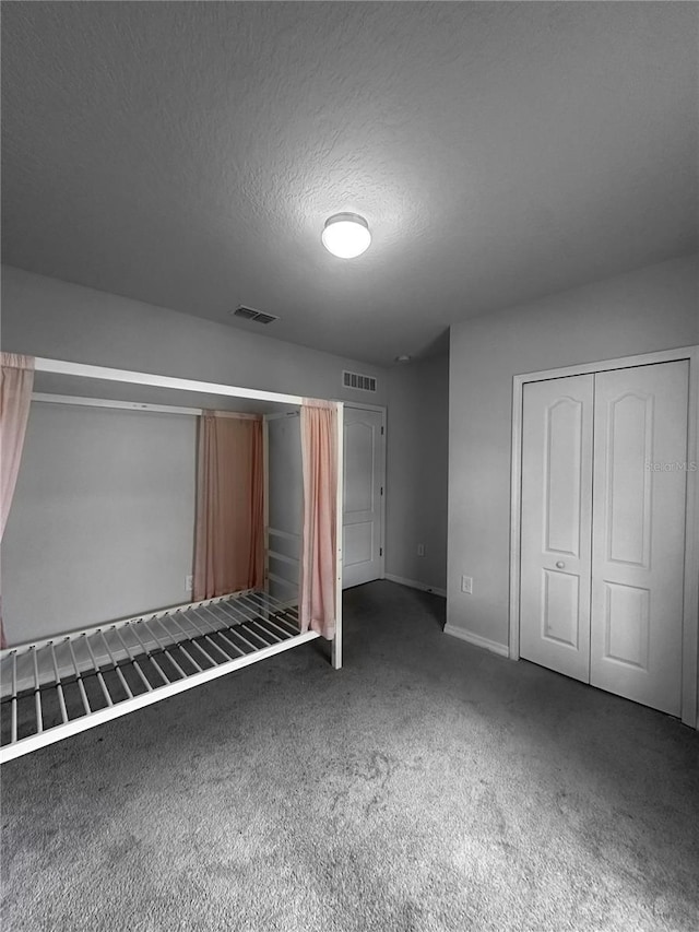388 Rooks Loop, Haines City, FL 33844 - unfurnished bedroom with carpet floors, a closet, and a textured ceiling