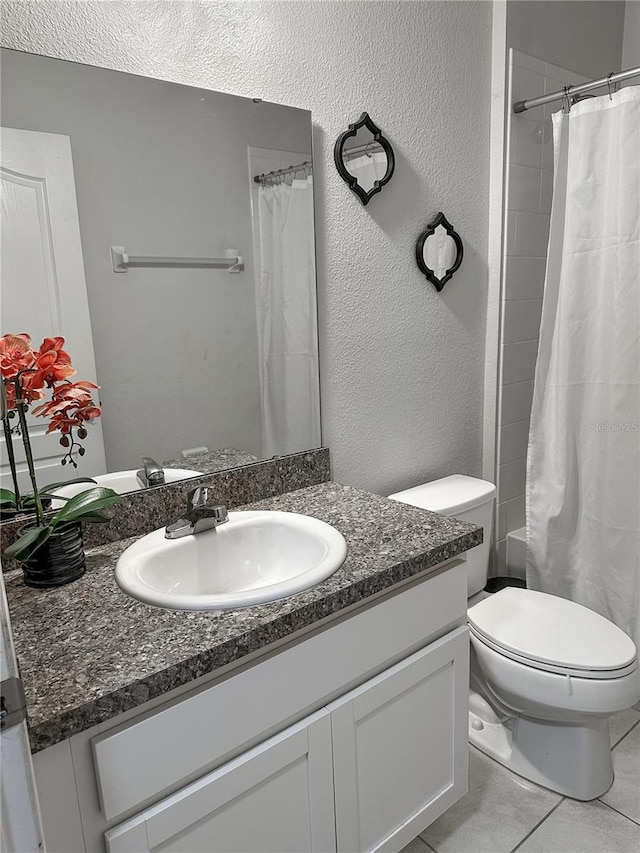 388 Rooks Loop, Haines City, FL 33844 - full bathroom featuring vanity, a shower with curtain, tile patterned floors, and a textured wall