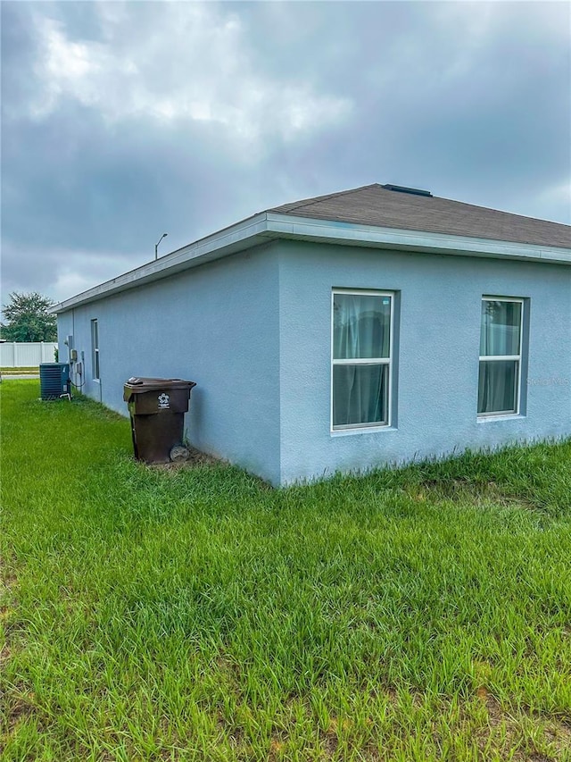 388 Rooks Loop, Haines City, FL 33844 - view of home's exterior with a yard and stucco siding