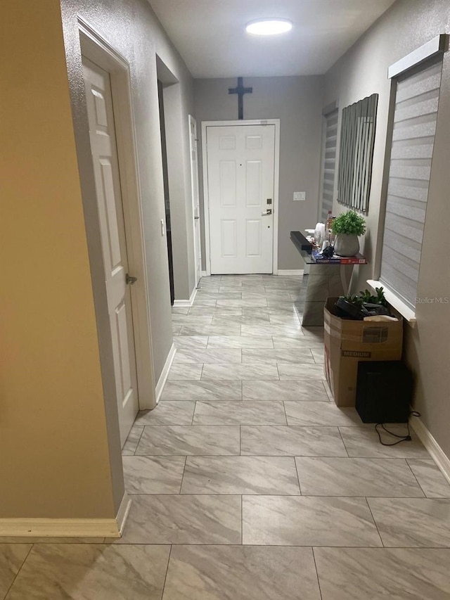 2618 San Simeon Way, Kissimmee, FL 34741 - hall featuring light marble finish flooring and baseboards
