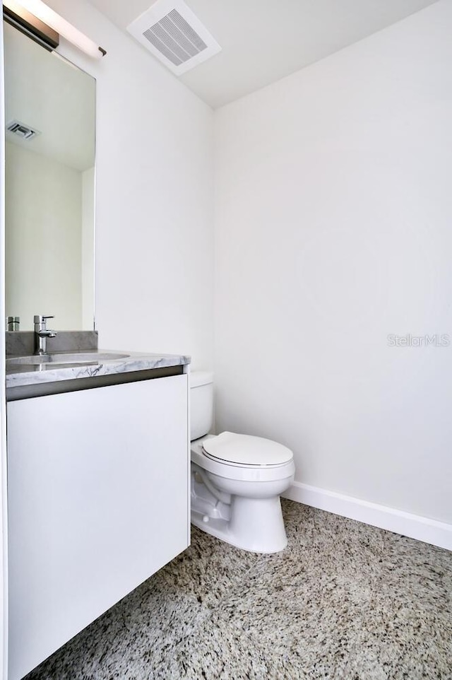 bathroom featuring toilet and vanity