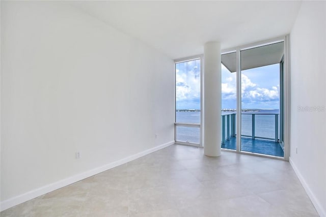 empty room with a water view and expansive windows