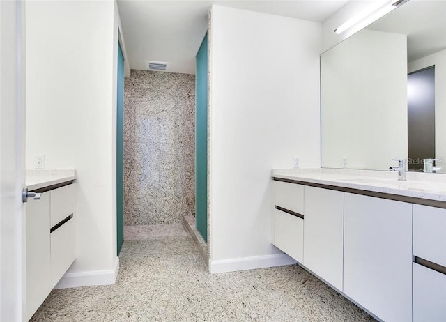 bathroom with walk in shower and vanity