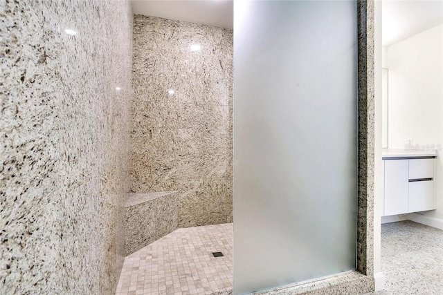 bathroom featuring vanity and a tile shower